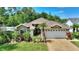 Beautiful home with lush garden, well-manicured lawn, and lovely curb appeal at 219 Breezy Oaks Ct, Davenport, FL 33896
