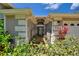 Inviting front entrance with a gated pathway and lush landscaping, enhancing curb appeal at 219 Breezy Oaks Ct, Davenport, FL 33896