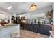 Well-equipped kitchen features a breakfast bar, stainless steel appliances, and ample countertop space at 219 Breezy Oaks Ct, Davenport, FL 33896