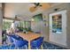 Enjoy outdoor dining on the lanai, complete with a ceiling fan, TV, and a view of the pool at 219 Breezy Oaks Ct, Davenport, FL 33896