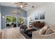 Bright living room overlooking pool, featuring hardwood floors at 219 Breezy Oaks Ct, Davenport, FL 33896