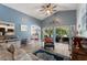 Bright living room with vaulted ceilings, hardwood floors, and large sliding doors leading to the pool area at 219 Breezy Oaks Ct, Davenport, FL 33896