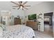 Bright main bedroom features a ceiling fan, two dressers, decor, and view into the house at 219 Breezy Oaks Ct, Davenport, FL 33896