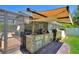 Outdoor kitchen with stone counter and stainless steel grill, perfect for outdoor entertaining and culinary adventures at 219 Breezy Oaks Ct, Davenport, FL 33896