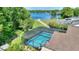 A relaxing screened-in pool offers beautiful lake views in a serene backyard setting at 219 Breezy Oaks Ct, Davenport, FL 33896