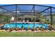 Inviting screened-in pool with lounge chairs and patio area, ideal for outdoor relaxation and entertaining at 219 Breezy Oaks Ct, Davenport, FL 33896