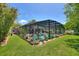Beautiful screened-in pool area surrounded by lush landscaping offers a private oasis for relaxation and recreation at 219 Breezy Oaks Ct, Davenport, FL 33896