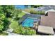 Beautiful screened-in pool with crystal blue water and a serene view of the lake at 219 Breezy Oaks Ct, Davenport, FL 33896