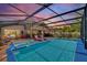 Relaxing screened-in pool area with a hot tub, lounge chairs, and ample seating for entertaining guests at 219 Breezy Oaks Ct, Davenport, FL 33896