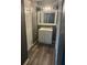 Bathroom with white vanity and cabinets, hard surface flooring, and new light fixture at 220 E Desoto St # C, Clermont, FL 34711