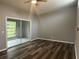 Bright bedroom featuring sliding glass doors, neutral paint, and hard surface flooring at 220 E Desoto St # C, Clermont, FL 34711