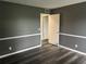 Bedroom with modern flooring, two-tone paint, and interior door at 220 E Desoto St # C, Clermont, FL 34711