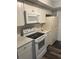 Well-lit kitchen featuring white cabinetry, updated countertops, and modern appliances at 220 E Desoto St # C, Clermont, FL 34711
