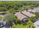 Aerial view of the home nestled among lush trees and well-manicured landscaping in a quiet neighborhood at 223 Bell Tower W Xing, Poinciana, FL 34759