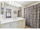A bright bathroom with a white vanity and a large mirror and a shower at 223 Bell Tower W Xing, Poinciana, FL 34759