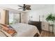 A bedroom featuring a ceiling fan, pillows and blankets, lamps, and dressers at 223 Bell Tower W Xing, Poinciana, FL 34759