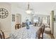 Inviting dining area with natural light, a view of the living room, and stylish decor at 223 Bell Tower W Xing, Poinciana, FL 34759