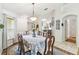 Bright dining room with charming chandelier and seating for six, perfect for intimate gatherings at 223 Bell Tower W Xing, Poinciana, FL 34759