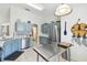 Well-designed kitchen with stainless steel appliances, blue cabinets, and a functional layout at 223 Bell Tower W Xing, Poinciana, FL 34759