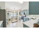 Well-lit kitchen with stainless appliances, ample counter space, and stylish blue cabinetry at 223 Bell Tower W Xing, Poinciana, FL 34759