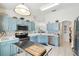 Spacious kitchen with stainless steel appliances, bright countertops, and stylish cabinetry at 223 Bell Tower W Xing, Poinciana, FL 34759