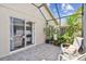 Enclosed patio with outdoor seating and potted plants at 223 Bell Tower W Xing, Poinciana, FL 34759