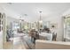 Open floor plan with dining table, living area, tile and wood flooring, and lots of natural light at 223 Bell Tower W Xing, Poinciana, FL 34759