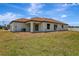 Back of home featuring multiple sliding glass doors and a lawn at 250 Beckenham Dr, Kissimmee, FL 34758