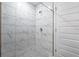 Walk-in shower featuring white marble tiling and pebble flooring at 250 Beckenham Dr, Kissimmee, FL 34758