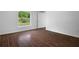 Bedroom with wood-style tile flooring and a window overlooking the backyard at 250 Beckenham Dr, Kissimmee, FL 34758