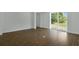 Bright bedroom featuring wood-style tile flooring and sliding glass doors to the backyard at 250 Beckenham Dr, Kissimmee, FL 34758