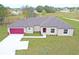 Charming single-story home featuring a two-car garage, manicured lawn, and an inviting front entrance at 250 Beckenham Dr, Kissimmee, FL 34758