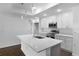 Modern kitchen featuring stainless steel appliances, quartz countertops, and a large island at 250 Beckenham Dr, Kissimmee, FL 34758