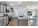 Modern kitchen showcasing granite countertops, stainless steel appliances, and stylish gray cabinetry at 250 Beckenham Dr, Kissimmee, FL 34758
