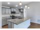 Modern kitchen with granite countertops, stainless steel appliances, and stylish gray cabinets at 250 Beckenham Dr, Kissimmee, FL 34758