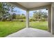 Covered patio providing a relaxing outdoor space overlooking a green backyard and nature at 250 Beckenham Dr, Kissimmee, FL 34758