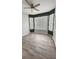 Cozy bedroom featuring a ceiling fan, wood floors, and unique wall accents at 2713 Barnsley Ln, Kissimmee, FL 34744