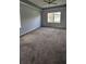 Spacious carpeted bedroom featuring natural light from the window and a ceiling fan at 2713 Barnsley Ln, Kissimmee, FL 34744