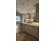Open kitchen featuring grey cabinetry, stainless appliances, and granite counters at 2713 Barnsley Ln, Kissimmee, FL 34744