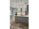 Updated kitchen featuring grey cabinets, stainless appliances, and pendant lighting at 2713 Barnsley Ln, Kissimmee, FL 34744