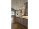 Well-appointed kitchen with an island, gray cabinetry, granite counters, and stainless steel appliances at 2713 Barnsley Ln, Kissimmee, FL 34744