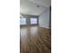 Bright living room with wood floors, gray walls, and vaulted ceilings offers a contemporary feel at 2713 Barnsley Ln, Kissimmee, FL 34744