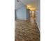 Spacious living room featuring wood-look tile flooring and neutral paint palette at 2713 Barnsley Ln, Kissimmee, FL 34744