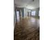 Open concept living room featuring wood-look tile flooring and modern lighting at 2713 Barnsley Ln, Kissimmee, FL 34744