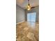 Open living room area with tile flooring, a ceiling fan, and a sliding glass door at 2713 Barnsley Ln, Kissimmee, FL 34744