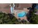 Aerial view of the community pool, spa, and surrounding buildings with lush landscaping and brick paver decking at 2725 N Poinciana Blvd # 147, Kissimmee, FL 34746