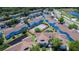 Community aerial showing pools, tennis courts, lush landscaping and plentiful parking areas at 2725 N Poinciana Blvd # 147, Kissimmee, FL 34746