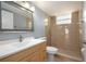 Bathroom featuring a tiled stand-up shower, a mirror, a sink with a cabinet, and a toilet at 2725 N Poinciana Blvd # 147, Kissimmee, FL 34746