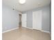 Clean bedroom with neutral walls and floors featuring a ceiling fan and a double door closet at 2725 N Poinciana Blvd # 147, Kissimmee, FL 34746