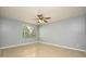 Open bedroom with a ceiling fan, a large window, and tan colored floors at 2725 N Poinciana Blvd # 147, Kissimmee, FL 34746